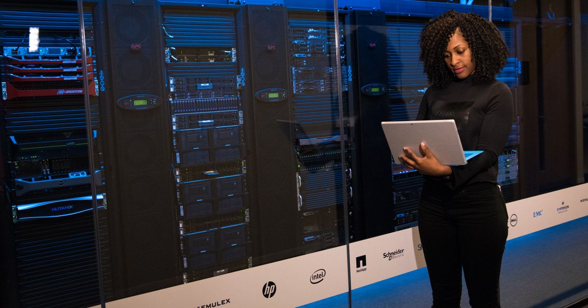 I.T. professional reviewing server infrastructure on a tablet in a data center